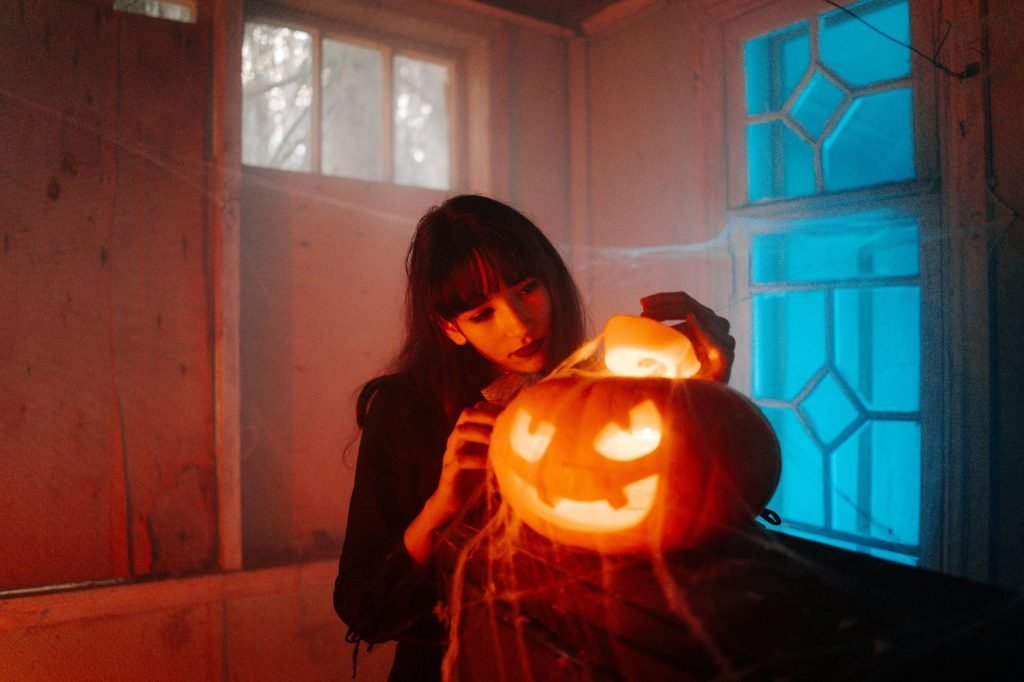 woman with a carved pumpkin